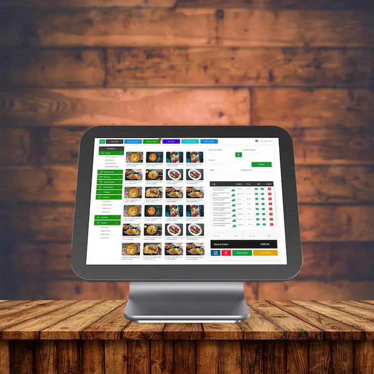Touchscreen POS terminal on a wooden counter showing a product menu and order total